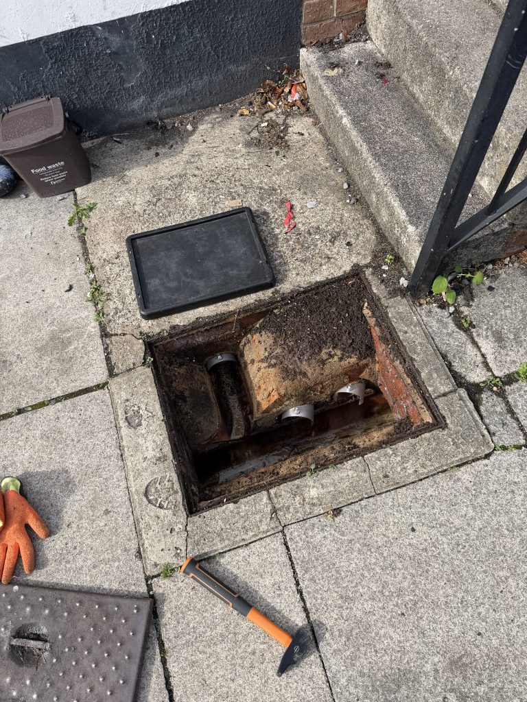 One-way rat blockers fitted to drain connections in an open inspection chamber in Chard