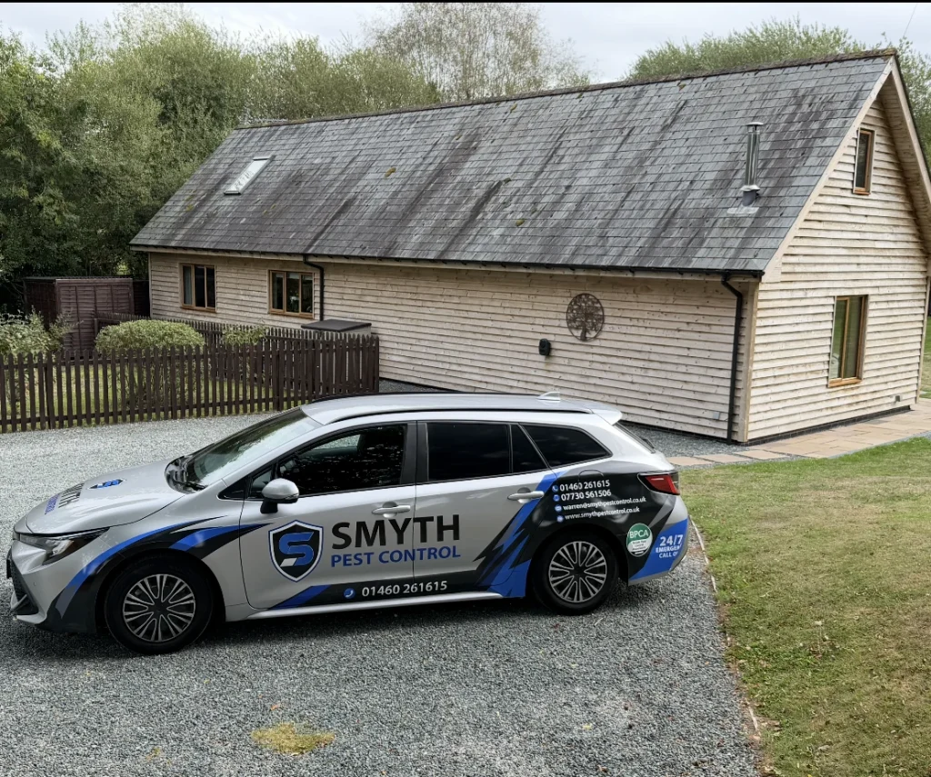 Smyth Pest Control vehicle outside a house